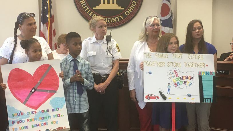 Khloe Warren (holding poster with the heart) of Riverview Elementary and Kaitlyn Roberts of Ridgeway Elementary were winners of a seat-belt safety slogan and poster contest, and were praised by Hamilton City Council on May 10. MIKE RUTLEDGE/STAFF