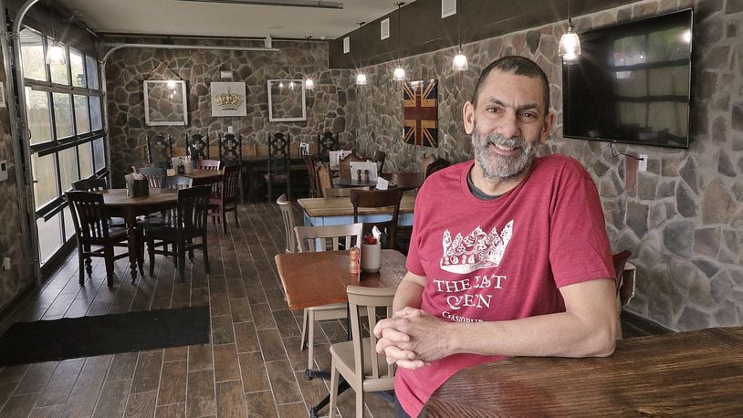Adrian Shergill, the owner of The Last Queen gastropub, has created the look and feeling of a British pub in Enon. From the food to the decor and even the smell of fish-n-chips cooking transports customers across the sea. BILL LACKEY/STAFF