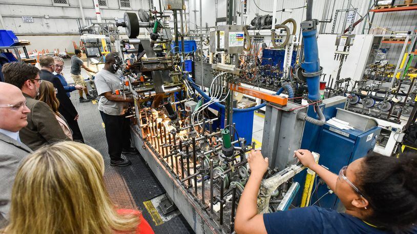 Employees work in the production area at Deceuninck North America Wednesday, March 28 in Monroe. Deceuninck has upgraded multiple extrusion lines and increased extrusion capacity. In addition, a nearly $30 million expansion means 250,000 square feet of warehouse space. NICK GRAHAM/STAFF