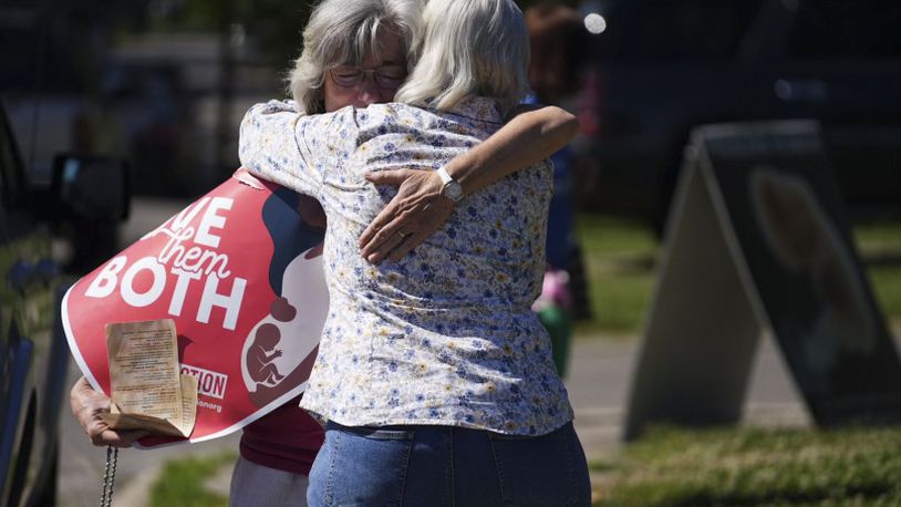 Mari Schoen  hugs a fellow supporter as they celebrate the overturning of Roe v Wade by the Supreme Court while standing outside of the Planned Parenthood Clinic in Columbus, Ohio, on Friday, June 24, 2022. The Supreme Court has ended constitutional protections for abortion that had been in place nearly 50 years in a decision by its conservative majority to overturn Roe v. Wade. Friday's outcome is expected to lead to abortion bans in roughly half the states.  (Courtney Hergesheimer/The Columbus Dispatch via AP)