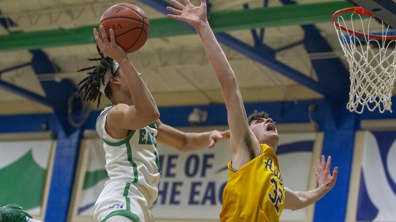 Chaminade Julienne's Evan Dickey scores over Alter's Charlie Uhl during CJ's 77-70 home victory Friday night. CONTRIBUTED/Jeff Gilbert