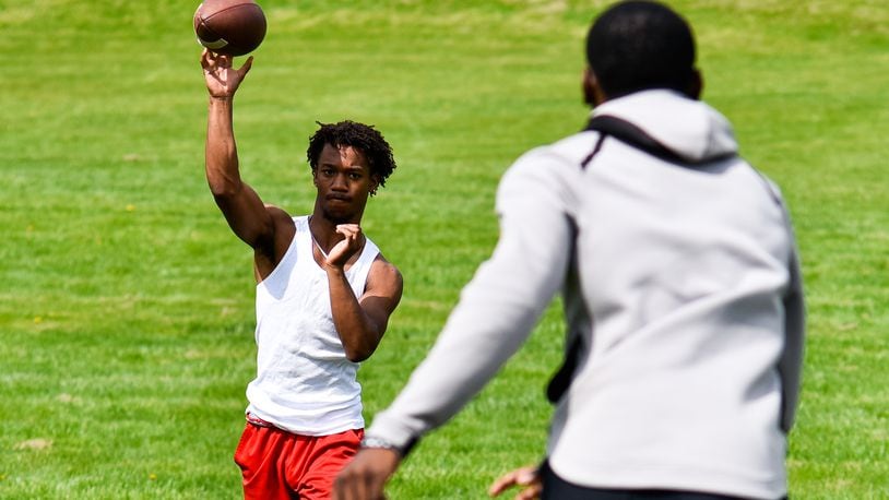 The city of Fairfield has seen an increase in use of its parks since the start of the novel coronavirus, or COVID-19, pandemic. Picture is Princeton graduate Jalen Turner throwing a pass to graduate Elijah Eberhardt in April at Harbin Park in Fairfield preparing for college athletics. Eberhardt is set to play football at Bowling Green State University and Turner is set to run track for a college in Georgia. NICK GRAHAM/STAFF