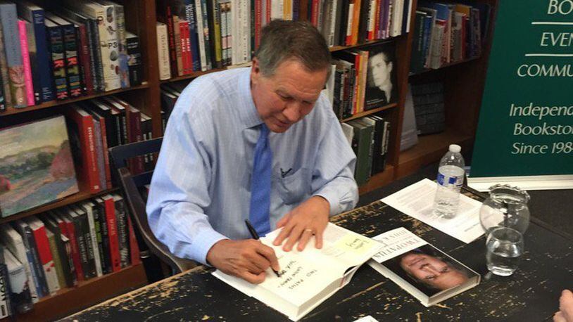 Gov. John Kasich signs books at bookstore in Washington on Friday. JACK TORRY/STAFF.