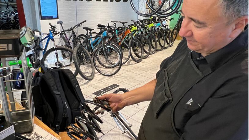 “I could get through these with a pair of side cutters in like 5 minutes,” BikeWise owner Doug Hamilton said as he handled a bike cable lock. JILLIAN INKS/OXFORD OBSERVER