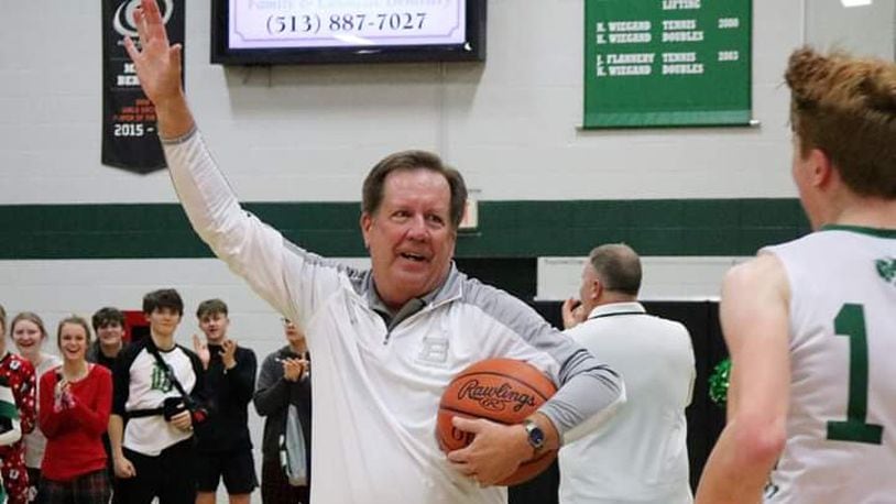 Badin coach Gerry Weisgerber waves to the crowd and heads toward his team after the Rams’ 43-42 victory over Carroll at Mulcahey Gym in Hamilton on Friday night. It was the 300th win of Weisgerber’s coaching career. CONTRIBUTED PHOTO BY TERRI ADAMS