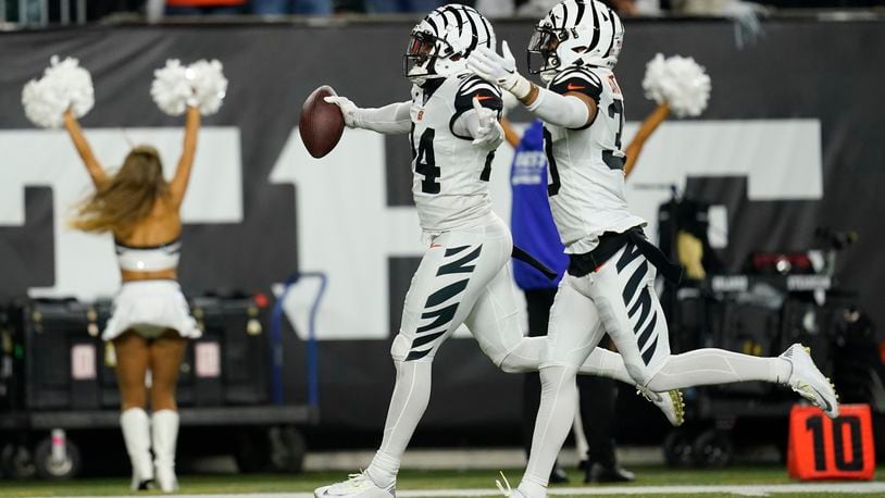 Cincinnati Bengals' Vonn Bell (24) celebrates an interception with Jessie Bates III (30) during the first half of an NFL football game against the Miami Dolphins, Thursday, Sept. 29, 2022, in Cincinnati. (AP Photo/Joshua A. Bickel)