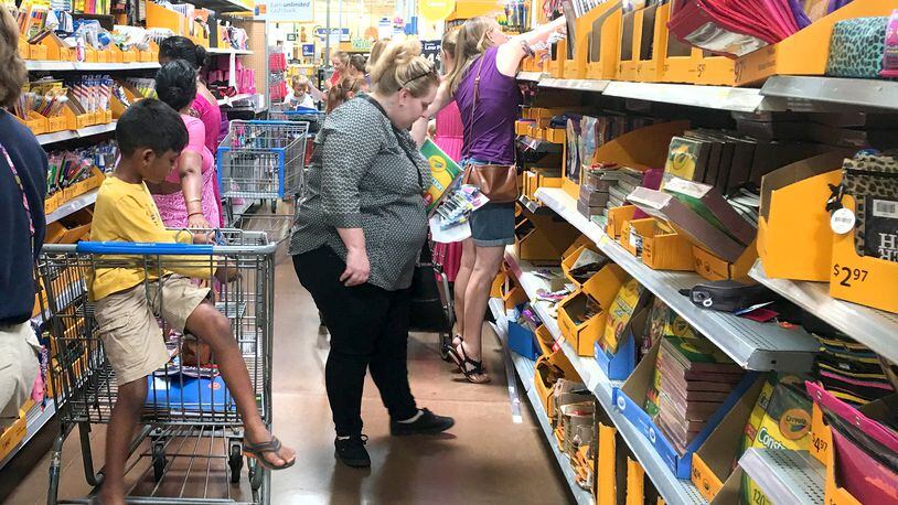 Two area Republican state legislators are proposing a bill that would prohibit county commissioners from increasing sales taxes without approval at the ballot box by registered voters. Here, Walmart shoppers are seen in Miami Twp. KARA DRISCOLL / STAFF
