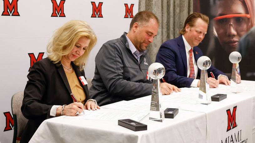 Miami Regionals held a signing ceremony for their WORK+ Healthcare partners Friday, April 14, 2023 at Miami University Hamilton campus. Kim Hensley, Chief Operating/chief Nursing Officer at Atrium Medical Center, left, Erik Balster, Health Commissioner for Butler county General Health District, middle, and Paul Hoover Jr., President of Kettering Health Hamilton, participated in the signing event. NICK GRAHAM/STAFF