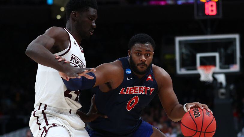 SAN JOSE, CALIFORNIA - MARCH 22: Myo Baxter-Bell of the Liberty Flames drives with the ball against Abdul Ado #24 of the Mississippi State Bulldogs during their game in the First Round of the NCAA Basketball Tournament at SAP Center on March 22, 2019 in San Jose, California. (Photo by Yong Teck Lim/Getty Images)