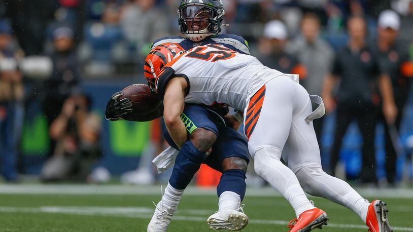 SEATTLE, WA - SEPTEMBER 08: Running back Chris Carson #32 of the Seattle Seahawks is tackled by linebacker Nick Vigil #59 of the Cincinnati Bengals at CenturyLink Field on September 8, 2019 in Seattle, Washington. (Photo by Otto Greule Jr/Getty Images)