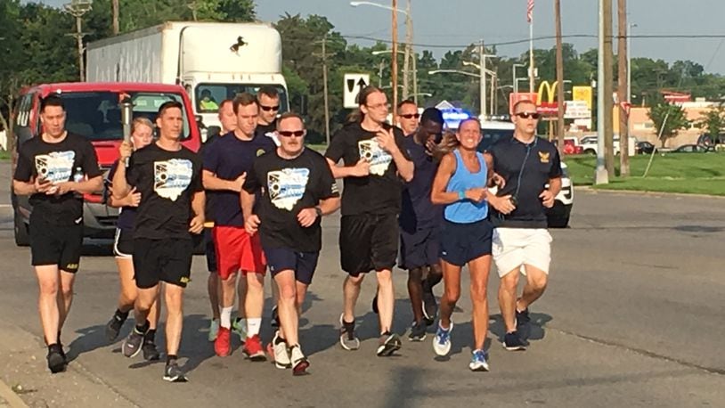 Middletown police officer Kim Robinson, in blue shirt, participated in her last Law Enforcement Torch Run this morning in Middletown. Robinson is retiring next year. RICK McCRABB/STAFF