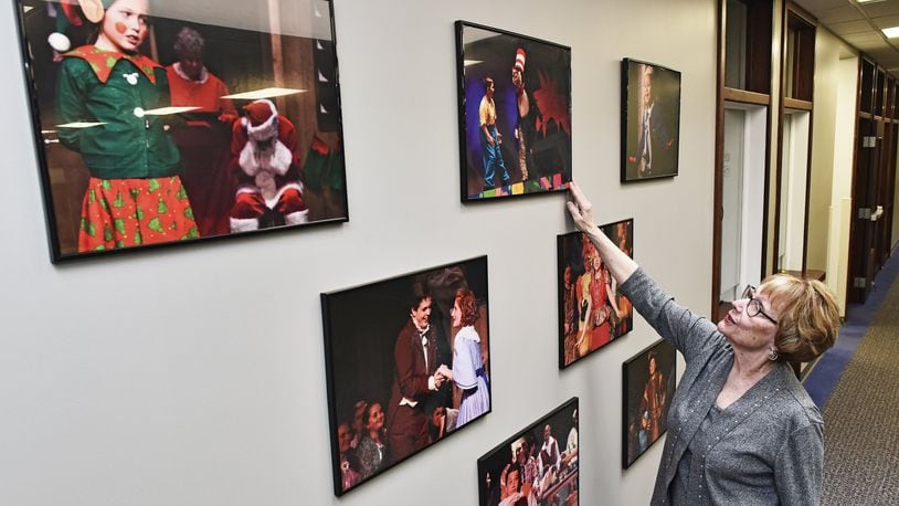 Nina Markle, executive director of the Performing Arts Academy, points to photographs of children performing in some of their plays inside the facility on Lewis Street in Middletown. The Performing Arts Academy offers individual lessons in Voice, piano, guitar, drums and other instruments and performs up to ten plays a year serving several hundred students. NICK GRAHAM/STAFF