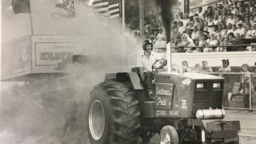Kent Dengler of Arcanum fires up his International tractor. He pulled the sled 297'6" to win the 8,000 lb. superstock class tractor pull at the Butler County Fair, July 28, 1988. JOURNAL-NEWS PHOTO ARCHIVE