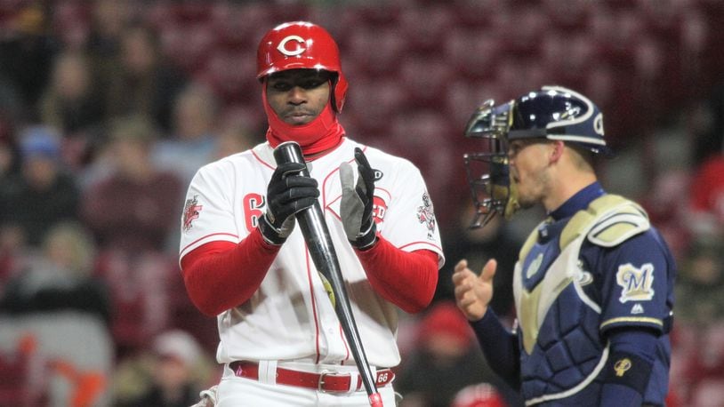 The Reds' Yasiel Puig bats in the ninth inning against the Brewers on Monday, April 1, 2019, at Great American Ball Park in Cincinnati.