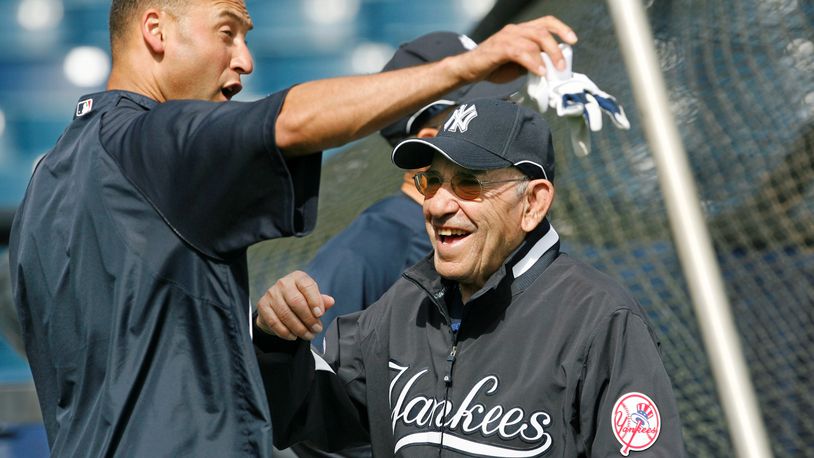 This March 7, 2008, file photo shows New York Yankees shortstop Derek Jeter, left, and Yogi Berra clowning around by the batting cage before the Yankees spring training baseball game against the Houston Astros at Legends Field in Tampa. Berra, the Yankees Hall of Fame catcher, has died. He was 90.