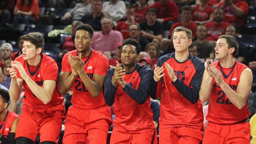 Dayton players (left to right: Sam Miller, Xeyrius Williams, John Crosby, Ryan Mikesell and Bobby Wehrli) cheer after a made free throw against Richmond on Tuesday, March 1, 2016, at the Robins Center in Richmond, Va. David Jablonski/Staff