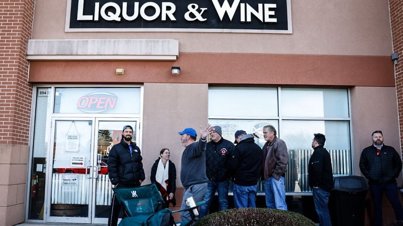 Customers wait in the cold to buy limited allocated bourbon at Centerville Liquor & Wine on South Mian Street in Centerville Friday, Feb. 24, 2023. Total sales of liquor increased in Ohio in 2022 by nearly 1%, while the amount of gallons sold decreased by nearly 1.8%. JIM NOELKER/STAFF