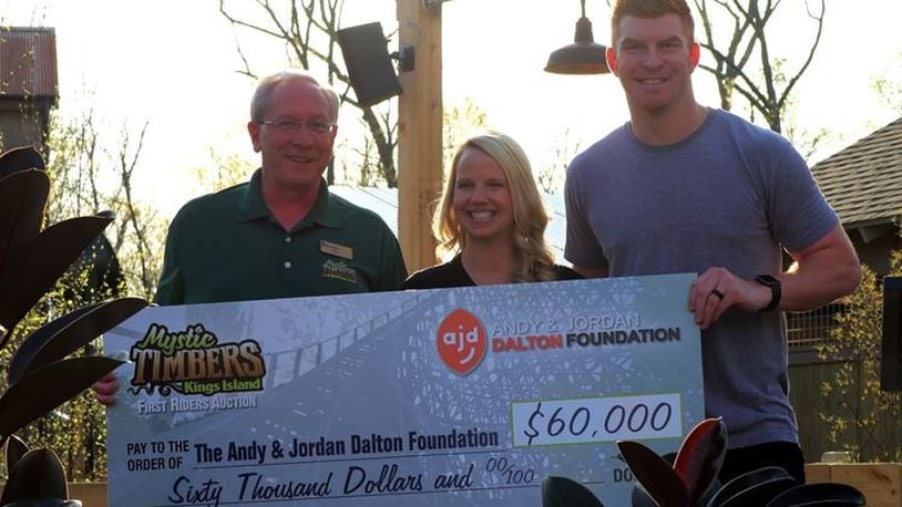 Mike Koontz, Kings Island vice president and GM, presents a check to Jordan and Andy Dalton on Thursday night, April 13, 2017, at Kings Island. (Courtesy/Kings Island)