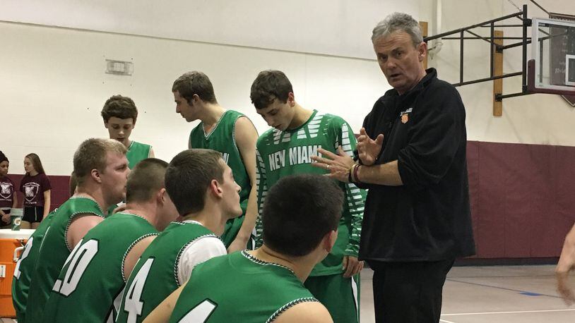 New Miami coach Dave Farrish talks to his team during a timeout Wednesday night at Mt. Auburn International Academy. Farrish’s Vikings posted a 63-34 victory. RICK CASSANO/STAFF