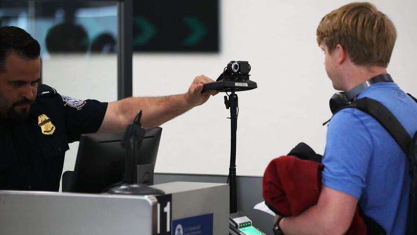 A U.S. Customs and Border Protection officer instructs an international traveler to look into a camera as he uses facial recognition technology to screen a traveler entering the United States on February 27, 2018 at Miami International Airport in Miami, Florida.  The facility is the first in the country that is dedicated to providing expedited passport screening via facial recognition technology, which verifies a traveler's identity by matching them to the document they are presenting.