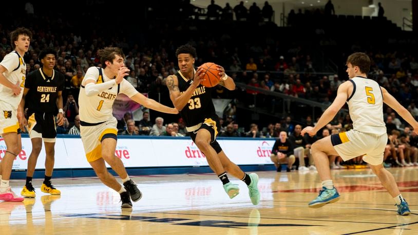 Centerville senior Jonathan Powell drives on Cleveland St. Ignatius' Michael Lamirand during the first half of Sunday night's Division I state final at UD Arena. Logan Howard/CONTRIBUTED