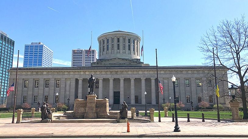 FILE PHOTO Flags fly at half staff in front of the Ohio Statehouse.