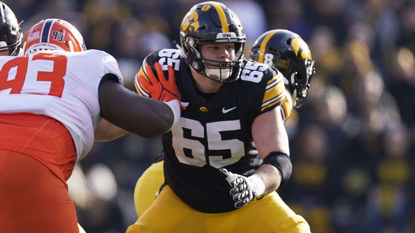 Iowa offensive lineman Tyler Linderbaum (65) looks to make a block during the first half of an NCAA college football game against Illinois, Nov. 20, 2021, in Iowa City, Iowa. (AP Photo/Charlie Neibergall)