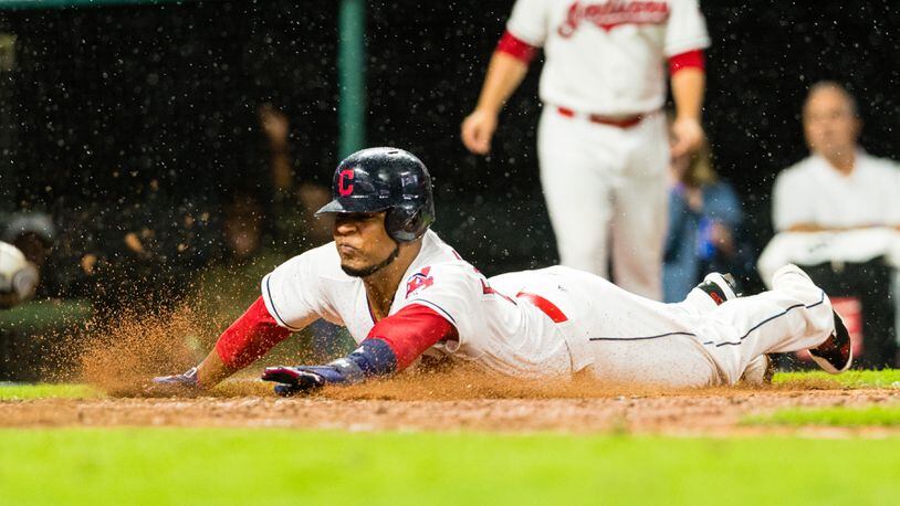 Cleveland Indians' Edwin Encarnacion scores on a hit by Carlos Santana during the seventh inning against the Texas Rangers at Progressive Field on June 26, 2017 in Cleveland.