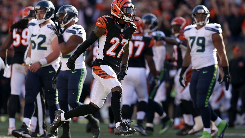 CINCINNATI, OH - OCTOBER 11: Dre Kirkpatrick #27 of the Cincinnati Bengals celebrates after sacking Russell Wilson #3 of the Seattle Seahawks during overtime at Paul Brown Stadium on October 11, 2015 in Cincinnati, Ohio. Cincinnati defeated Seattle 27-24 in overtime. (Photo by Andy Lyons/Getty Images)