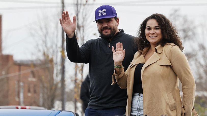 Kyle Schwarber and wife, Paige, wave at the crowd during the Middletown Santa Parade Saturday, Nov. 26, 2022 in downtown Middletown. Middletown native Kyle Schwarber served as grand marshal. NICK GRAHAM/STAFF