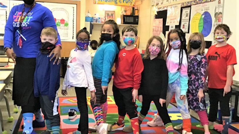 Across Butler and Warren county schools this week, school days have magically transformed into school "deys" in honor of  Super Bowl-bound "Who Dey!" Cincinnati Bengals. Fairfield West Elementary teacher Jennifer Moore joins her students in flashing their colorful and mismatched socks on the district's "Crazy Socks Even McPherson Dey" earlier this week. CONTRIBUTED
