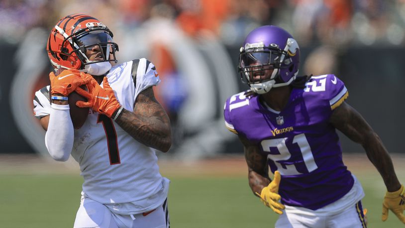Cincinnati Bengals wide receiver Ja'Marr Chase (1) makes a catch past Minnesota Vikings defensive back Bashaud Breeland (21) and takes it in for a touchdown in the first half of an NFL football game, Sunday, Sept. 12, 2021, in Cincinnati. (AP Photo/Aaron Doster)