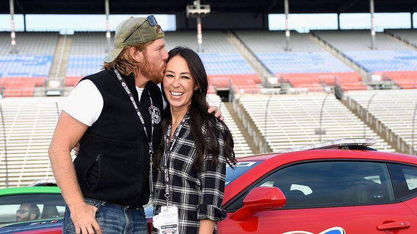 'Fixer Upper' stars Chip and Joanna Gaines pose with the Monster Energy NASCAR Cup Series AAA Texas 500 pace car (Photo by Jared C. Tilton/Getty Images)