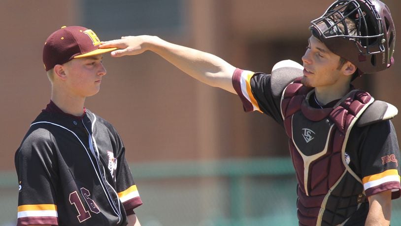 Ross catcher Andrew Beebe (right) consoles pitcher Paul Schroeder during a Division II regional semifinal against Cincinnati Hills Christian Academy on May 24 at Mason. DAVID JABLONSKI/STAFF