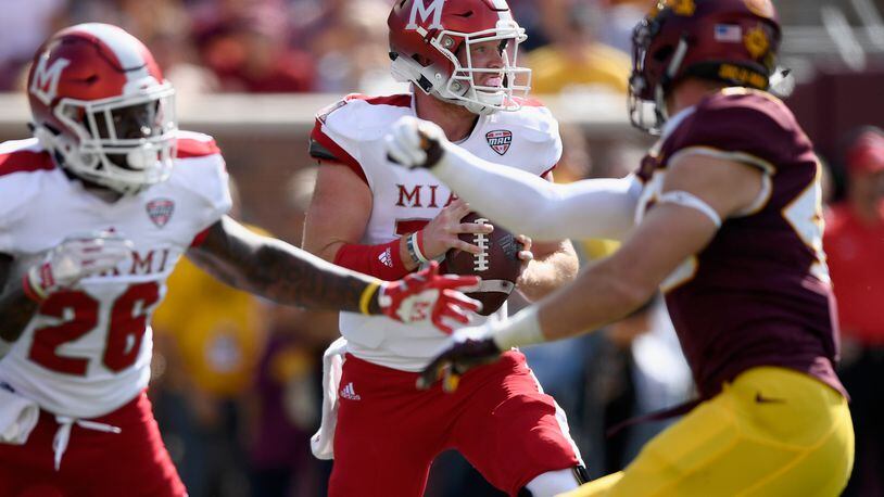 Gus Ragland #14 of the Miami RedHawks looks to pass the ball against the Minnesota Golden Gophers during the first quarter of the game on September 15, 2018 at TCF Bank Stadium in Minneapolis, Minnesota. (Photo by Hannah Foslien/Getty Images)