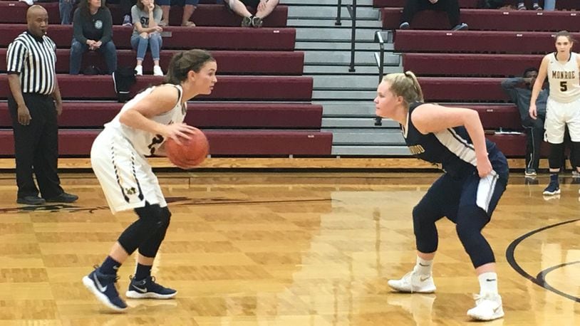 Monroe’s Brooke Frazier (left) goes head-to-head with Oakwood’s Abby Duwel (3) during Tuesday night’s Division II sectional semifinal at Lebanon. RICK CASSANO/STAFF