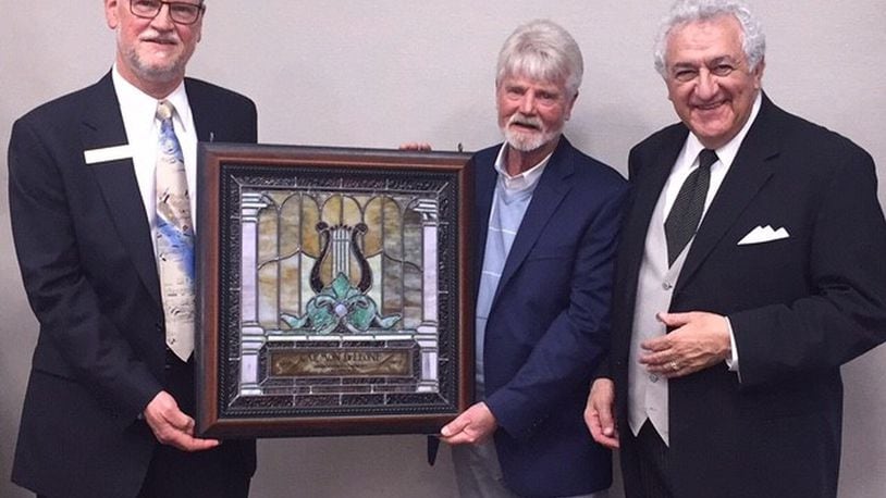 Carmon DeLeone, music director of the Middletown Symphony Orchestra, celebrated 35 years leading the orchestra and was presented with stained glass art created by Jay Moorman of Beauvre Stained Glass. Pictured left to right: Steve Ifcic, president of the board Middletown Symphony, Jay Moorman and DeLeone.