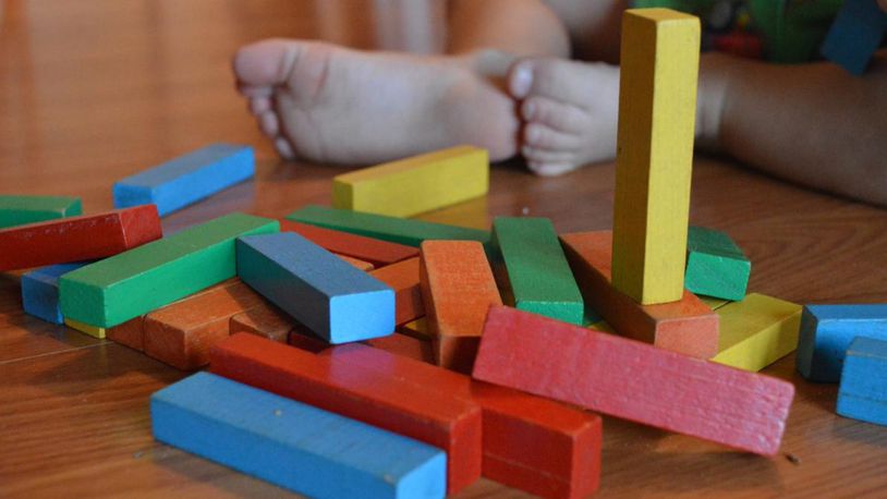 Image of child playing with toy blocks.