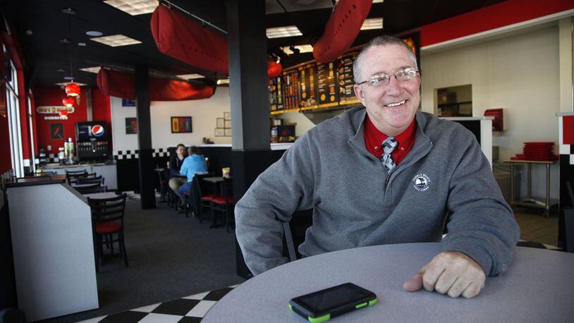 In this 2014 photo, Ray Wiley, founder of Hot Head Burritos and Rapid Fired Pizza, sits inside his Hot Head Burritos store at 1120 E. Stroop Road in Kettering. Wiley is also co-founder of another new restaurant venture, Wiley's Wings, Tenders and Fries. FILE