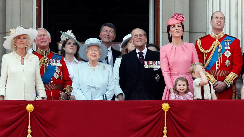 Members of Britain's Royal family from left, Camilla, the Duchess of Cornwall, Prince Charles, Princess Eugenie, Queen Elizabeth II, background Timothy Laurence, Princess Beatrice,  Prince Philip, Kate, the Duchess of Cambridge, Princess Charlotte, Prince George and Prince William watch a fly past as they appear on the balcony of Buckingham Palace, after attending the annual Trooping the Colour Ceremony in London, Saturday, June 17, 2017. (AP Photo/Kirsty Wigglesworth)
