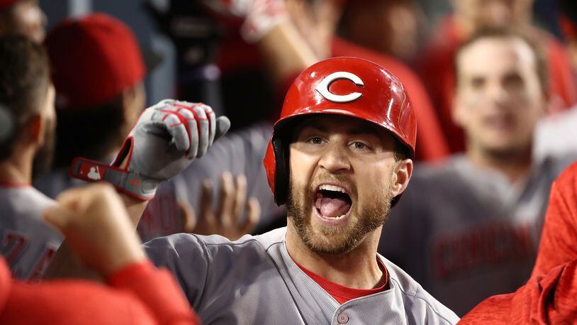 LOS ANGELES, CA - MAY 12: Scott Schebler #43 of the Cincinnati Reds celebrates with teammates in the dugout after hitting a three-run homerun to take a 4-3 lead in the sixth inning of the MLB game against the Los Angeles Dodgers at Dodger Stadium on May 12, 2018 in Los Angeles, California. The Reds defeated the Dodgers 5-3. (Photo by Victor Decolongon/Getty Images)