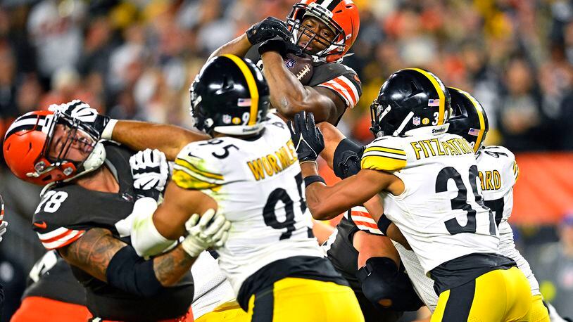 Cleveland Browns running back Nick Chubb, top, leaps into the end zone for a touchdown during the second half of the team's NFL football game against the Pittsburgh Steelers in Cleveland, Thursday, Sept. 22, 2022. (AP Photo/David Richard)