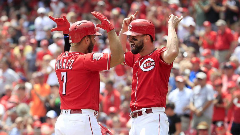 Eugenio Suarez (left) of the Cincinnati Reds celebrates with Jesse Winker after hitting a home run in the third inning against the Pittsburgh Pirates at Great American Ball Park on July 31, 2019 in Cincinnati. (Photo by Andy Lyons/Getty Images)