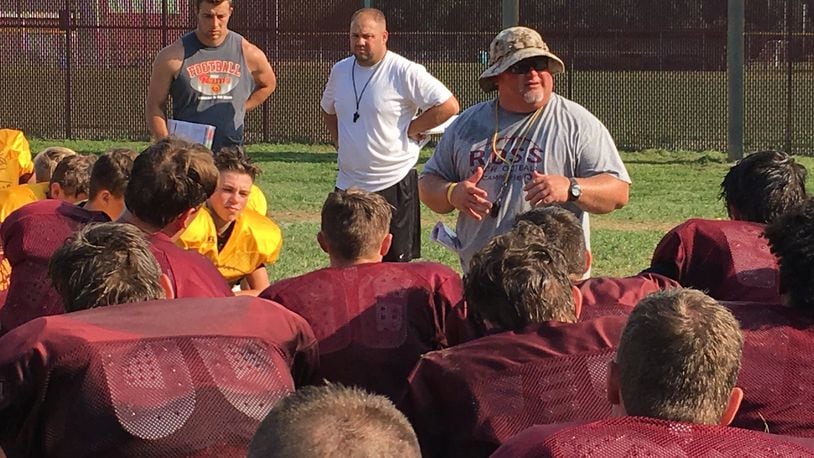 Ross coach Kenyon Commins talks to his team after practice at the school Monday. RICK CASSANO/STAFF