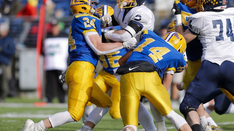 Marion Local's Darren Meier (24) and teammate Landon Arling (14) make a tackle against Kirtland in the Division VI state football championship in Canton on Saturday, Dec. 3, 2022. Meier was named Ohio's Division VI Co-Defensive Player of the Year on Monday. Michael Cooper/CONTRIBUTED