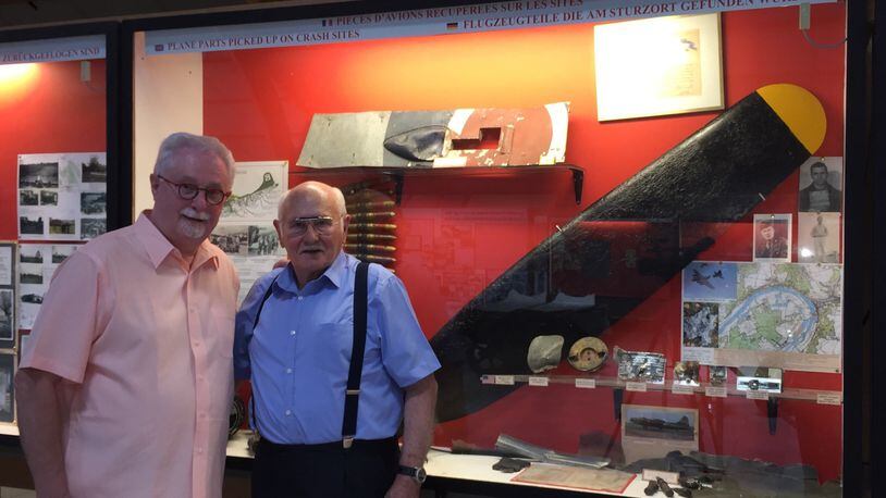 Sam Ashworth, left, a Middletown historian, visited a World War II museum four years ago operated by Jean Erisay. They're pictured in front of the display that includes a propeller off a bomber that was shot down in 1942. The propeller is being shipped from France to Middletown and will be on display in the Middletown Historical Society. SUBMITTED PHOTO.