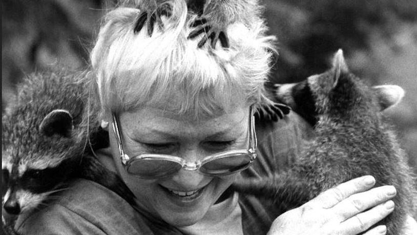 Mary Hamen and her raccoon friends in this 1987 photo.