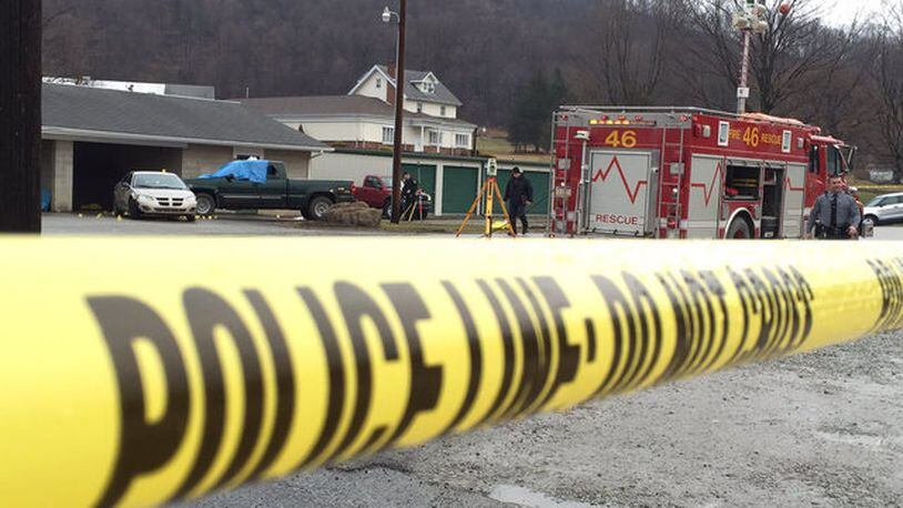 Authorities investigate in Melcroft, Pennsylvania, on Sunday, Jan. 28, 2018, after police said a man shot and killed four people at a car wash.