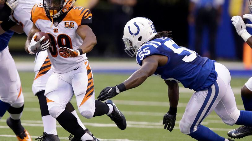 Cincinnati Bengals running back Jarveon Williams, left, runs with the ball as Indianapolis Colts linebacker Sean Spence, right, defends during the first half of a preseason NFL football game in Indianapolis, Thursday, Aug. 31, 2017. (AP Photo/Michael Conroy)