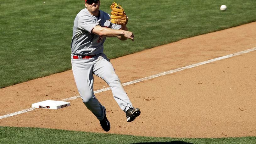 Cincinnati Reds third baseman Scott Rolen throws out San Francisco Giants’ Buster Posey during the seventh inning of a baseball game in San Francisco, Wednesday, Aug. 25, 2010. (AP Photo/Marcio Jose Sanchez)
